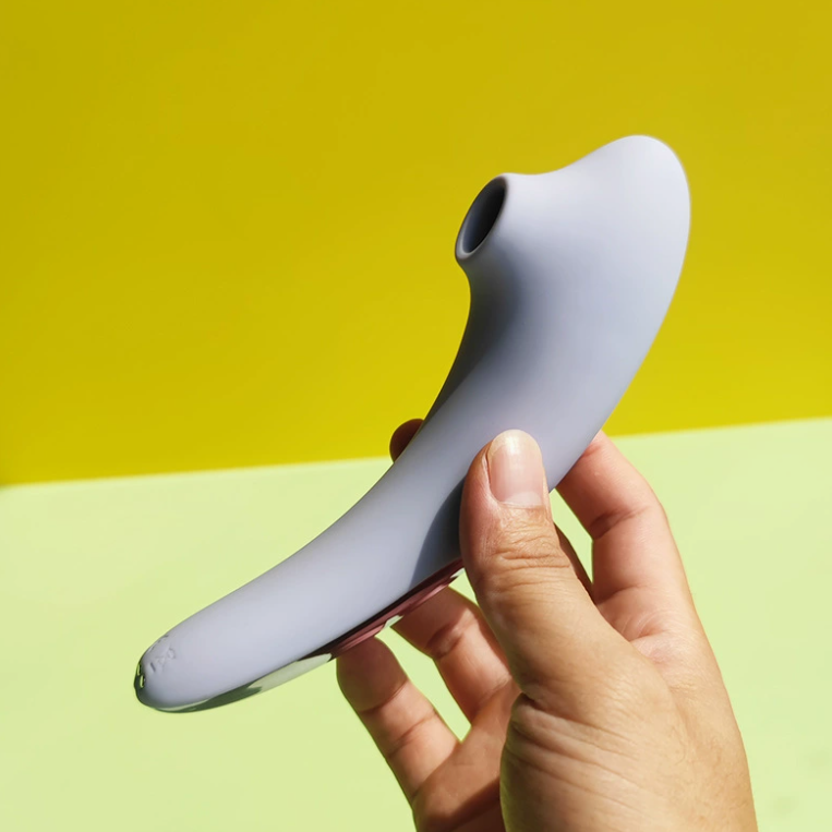 Lavender ergonomic crescent-shaped air-pulse clitoral stimulator with sculpted control ring for wholesale B2B distribution